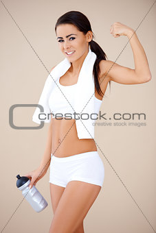 Happy fitness girl showing her muscles