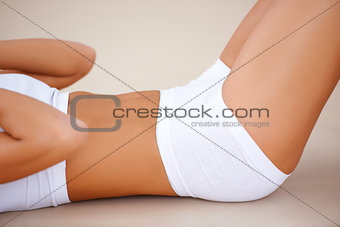 Body part of fit woman  she doing exercises