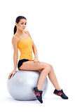 Athletic woman relaxing on fitness ball