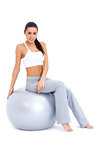 Athletic woman relaxing on fitness ball