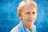 happy old blond woman smiling and looking at camera