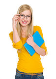 Smiling student girl in glasses with book