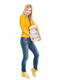 Full length portrait of happy student girl holding stack of book