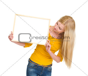 Student girl looking on blank board