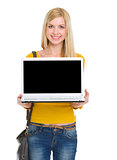 Smiling student girl showing laptop