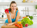 Portrait of happy young woman ready to make vegetable salad