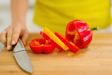 Closeup on red bell pepper with yellow slice on cutting board