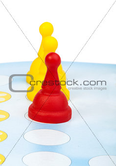 Red and yellow game pawns white isolated