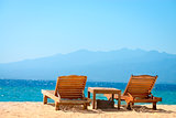 Beach chairs on tropical yellow sand beach