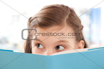 Girl reading a book at school