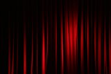 Part of a red curtain in a theatre.