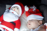 A young boy sleeping with santa