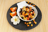 Dried fruits on stone plate with flower