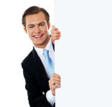 Smiling business professional behind blank clipboard
