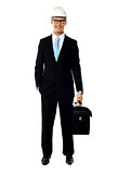 Portrait of smiling young architect carrying briefcase