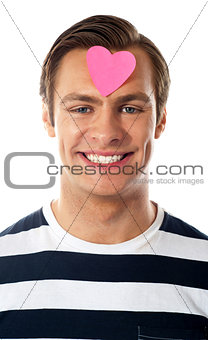 Closeup of an attractive man with paper heart