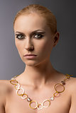 blonde girl with necklace in front of the camera