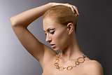 blonde girl with necklace takes her hair