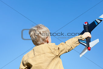boy holding a plane