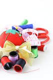 sewing utensils - coils colored threads, pins, thimble