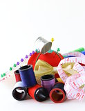 sewing utensils - coils colored threads, pins, thimble