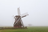 wooden windmill in fog