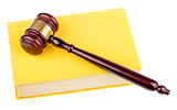 Wooden gavel on yellow book