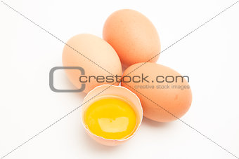 Three eggs with a yolk in half a shell