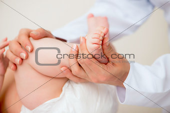 mother massaging baby