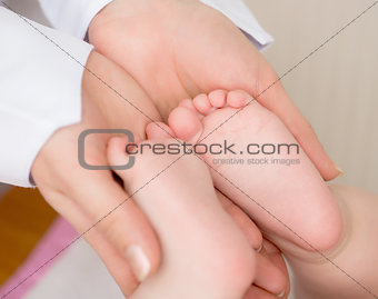 Doctor massaging  baby