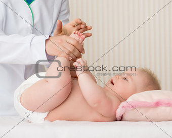 mother massaging baby