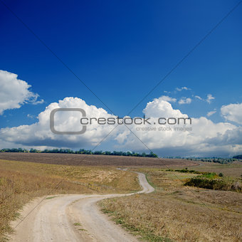 rural road under dramatic cloudy sky