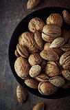 Bowl of rustic walnuts and almonds
