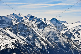 Winter mountains landscape and paragliding