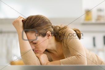 Stressed young housewife in kitchen