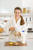 Smiling young woman making healthy breakfast