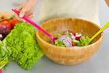 Closeup on housewife mixing vegetable salad