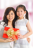 Asian girl giving a gift to her happy mother