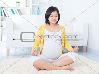 Asian pregnant woman meditating