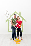 Happy couple painting their home