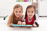 Little girls using tablet computer as artboard