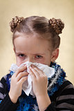 Little girl with the flu - blowing nose