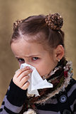 Little girl in flu season - blowing nose
