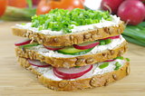 three slices of bread with cottage cheese and the vegetables