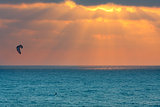 Kitesurfer on Mediterranean sea at sunset in Israel.