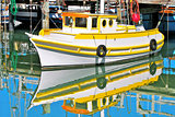 Fishing boat reflected in the water in San Francisco, USA.