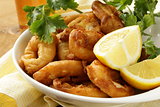 fried squid rings dipped in batter with lemon