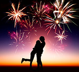 happy young couple with fireworks background