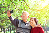 Senior couple taking picture of themselves outdoor