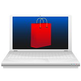 On line shopping concept. Red shopping bag at laptop screen.